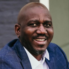 Samuel Imoisili, Associate Broker, in a professional setting.